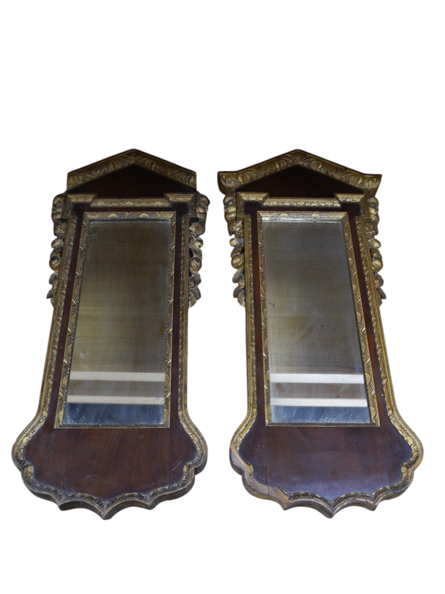 A pair of late 19th / early 20th century mahogany pier glass mirrors in George II style, 75 x 33cm. Condition - fair